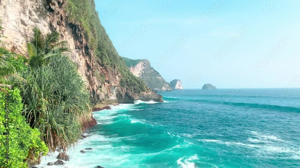 Amazing view of big waves crashing against cliffs at Guyangan waterfall, Nusa penida tourism in Bali, Indonesian coastline Amazing view of big waves crashing against cliffs at Guyangan waterfall, Nusa penida tourism in Bali, Indonesian coastline
