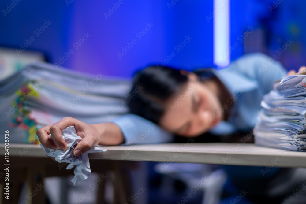 A woman is sleeping on a desk with a pile of papers in front of her A woman is sleeping on a desk with a pile of papers in front of her