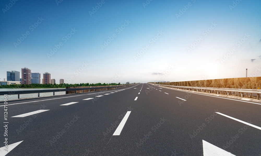 Serene Highway Perspective with Urban Backdrop and Clear Sky Serene Highway Perspective with Urban Backdrop and Clear Sky