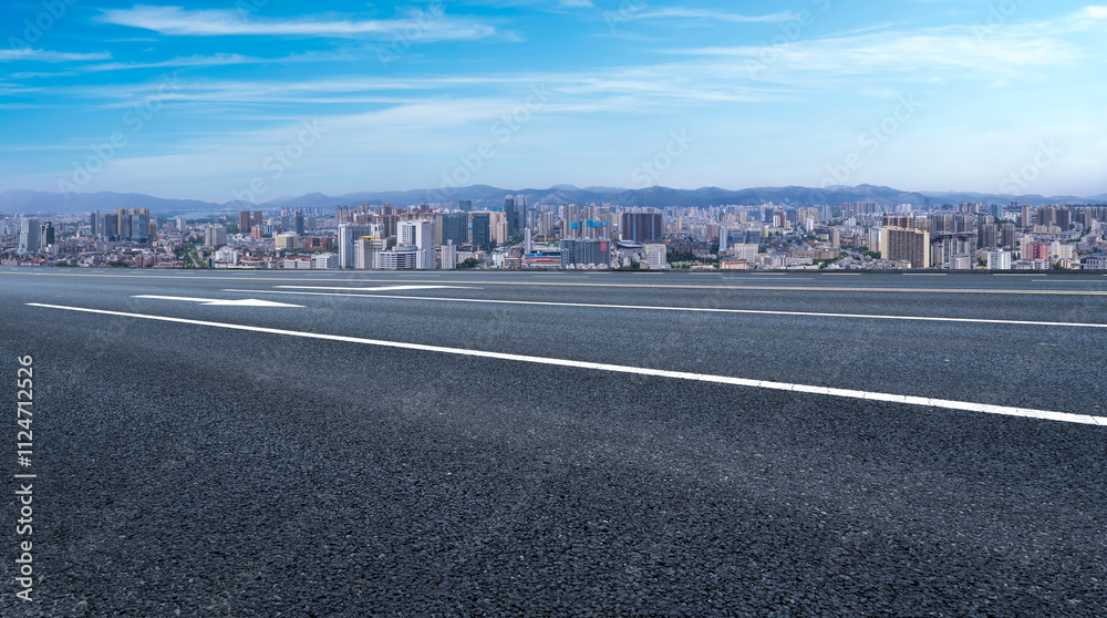 Expansive Urban Roadway with Skyline View Under Clear Blue Skies Expansive Urban Roadway with Skyline View Under Clear Blue Skies