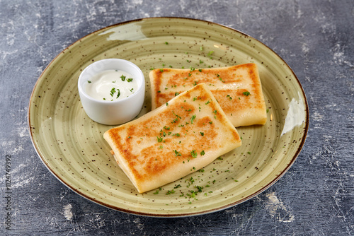 pancakes with sour cream and herbs photo