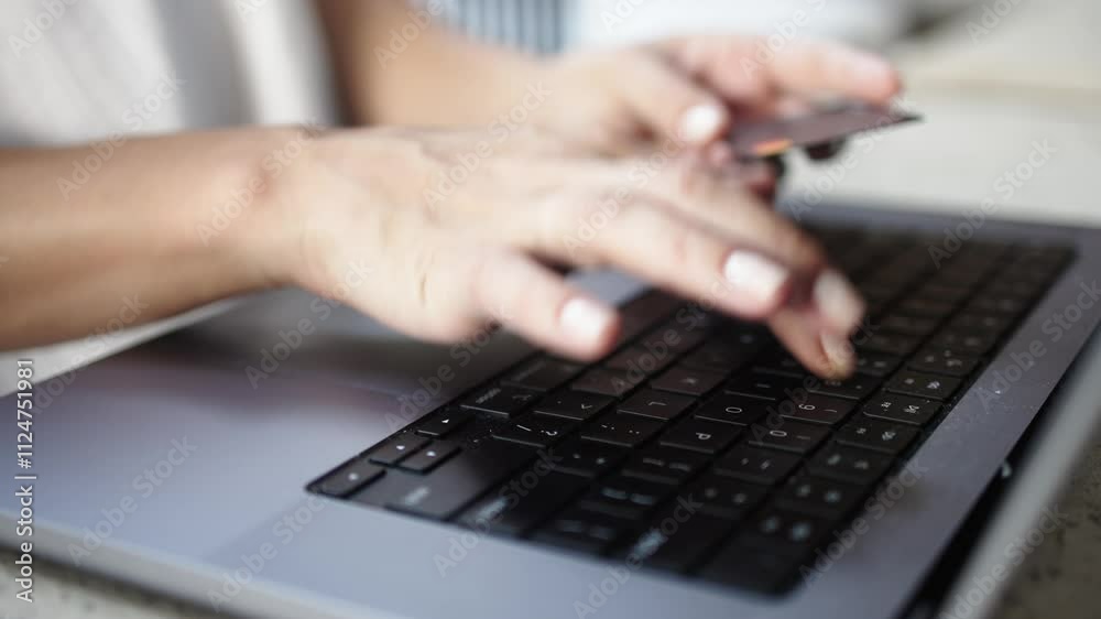 Close-up of female hands entering card details on a laptop, followed by cash banknotes appearing. Concept of online payments, e-commerce, digital transactions and credit. Close-up of female hands entering card details on a laptop, followed by cash banknotes appearing. Concept of online payments, e-commerce, digital transactions and credit.