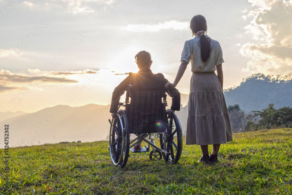 Silhouette woman in wheelchair with his care helper looking sunset. Silhouette woman in wheelchair with his care helper looking sunset.