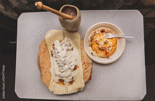 Quesillo with pupusa served on the table with traditional cocoa drink. Traditional pupusas with Quesillo served on the table photo