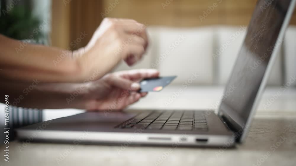 Close-up of female hands entering card details on a laptop, followed by cash banknotes appearing. Concept of online payments, e-commerce, digital transactions and credit. Close-up of female hands entering card details on a laptop, followed by cash banknotes appearing. Concept of online payments, e-commerce, digital transactions and credit.