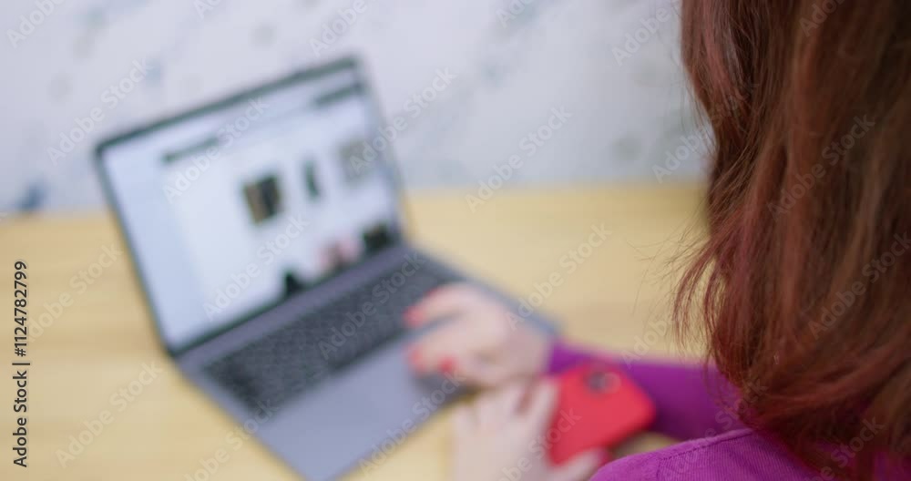 Young woman calls salesperson after choosing right thing in online store. Relaxed businesswoman does shopping online sitting at cafe table