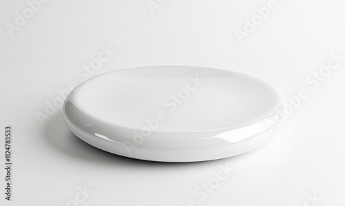 White ceramic dish, smooth surface, minimalist design, round shape, glossy finish, suitable for serving or decoration