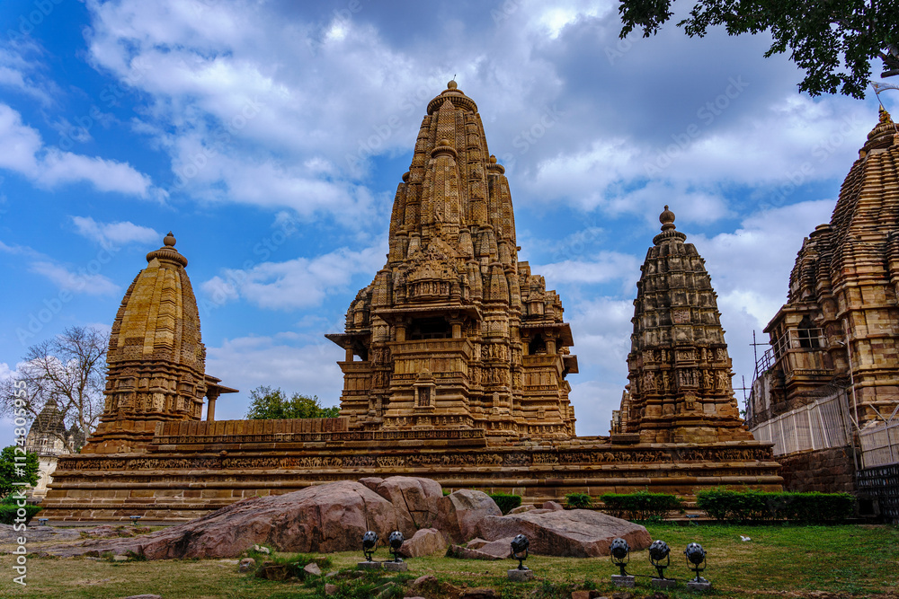 India. Madhya Pradesh state. The Khajuraho Group of Monuments are a group of Hindu and Jain temples. Lakshmana temple under a blue sky India. Madhya Pradesh state. The Khajuraho Group of Monuments are a group of Hindu and Jain temples. Lakshmana temple under a blue sky