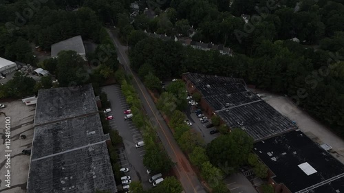 Aerial view of Doraville neighborhood townhouses, industrial office spaces surrounded with green trees in the evening photo