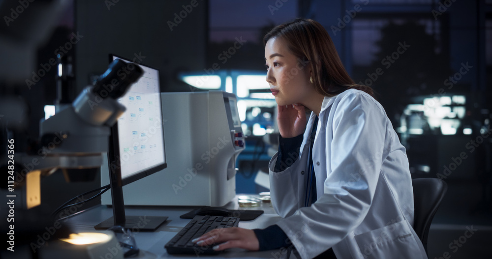 Medical Research and Development Laboratory: Tired Japanese Female Scientist Working on a Computer with Advanced DNA Diagnostic Software. Modern Genetic Engineering Lab at Night Medical Research and Development Laboratory: Tired Japanese Female Scientist Working on a Computer with Advanced DNA Diagnostic Software. Modern Genetic Engineering Lab at Night