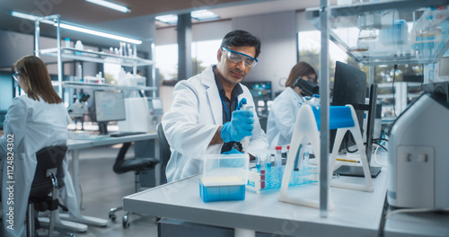 Obraz na plátně Medical Research Laboratory: Portrait of a Handsome Indian Scientist Using Micropipette for Test Analysis