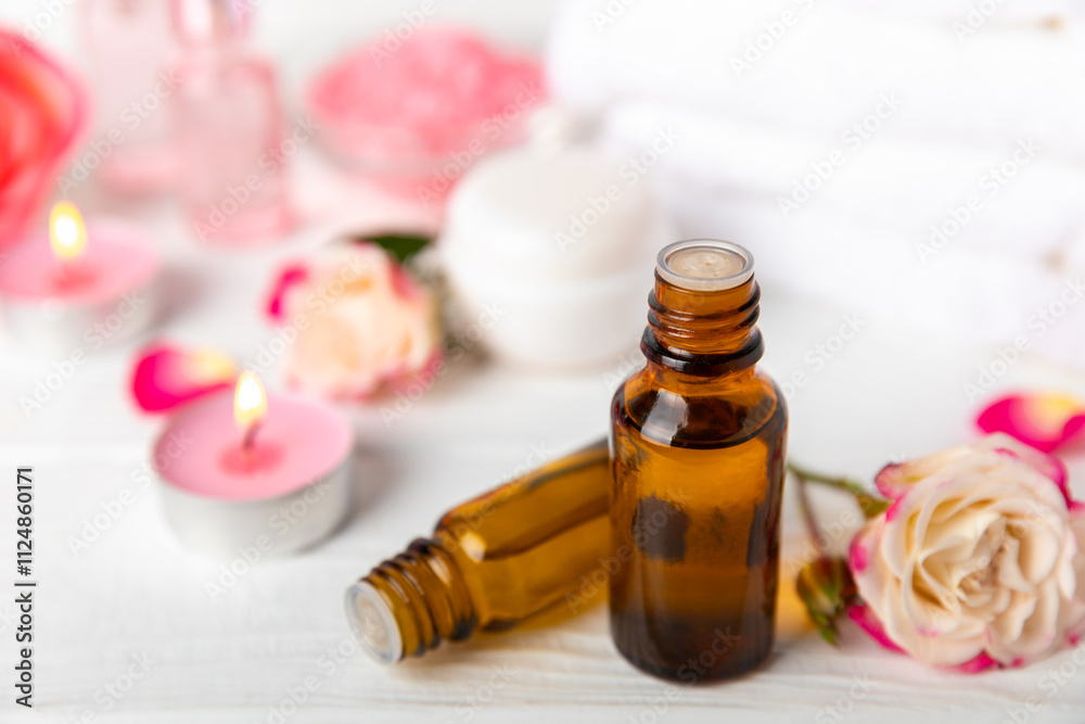 Rose essential oil on a textured background.Roses and a bottle of rose perfumed water.Aromatherapy treatment. Beauty concept. Spa procedure.Natural organic oil.Anti-stress,detox relax.Place for text Rose essential oil on a textured background.Roses and a bottle of rose perfumed water.Aromatherapy treatment. Beauty concept. Spa procedure.Natural organic oil.Anti-stress,detox relax.Place for text