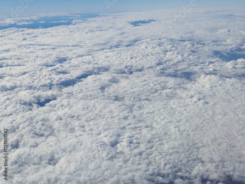 Airplane flying over white clouds background