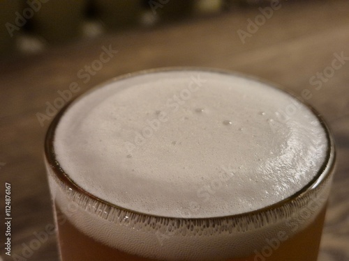 Chilled Beer in Drinkware with Foam on Tableware