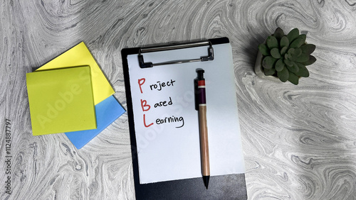 Concept of PBL - Project Based Learning write on paperwork isolated on Wooden Table. photo