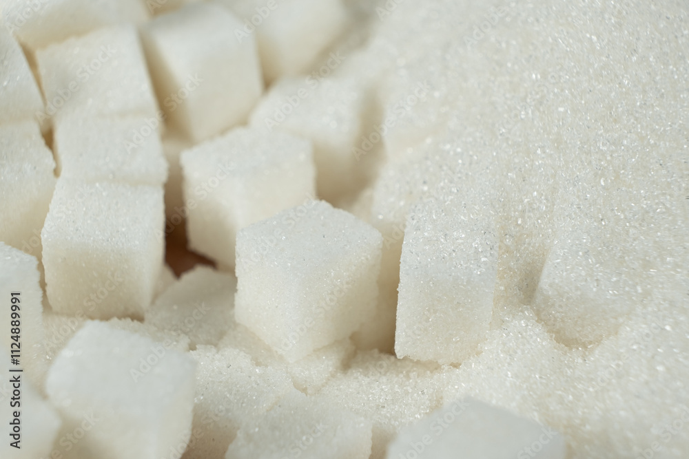 White refined beet sugar in the form of crystals and cubes. White refined beet sugar in the form of crystals and cubes.