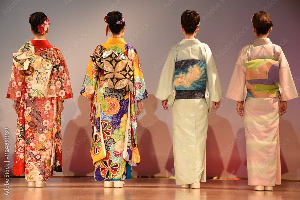Four Japanese women with black hair wearing kimonos and obi belts with traditional floral and geometric patterns. Elegant and colourful design of Kyoto Nishiki Textile Center. Four Japanese women with black hair wearing kimonos and obi belts with traditional floral and geometric patterns. Elegant and colourful design of Kyoto Nishiki Textile Center.