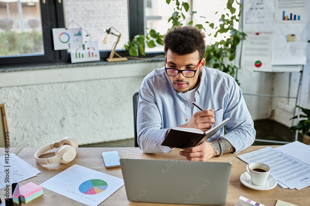 A handsome man writes notes while analyzing data in a modern office filled with greenery A handsome man writes notes while analyzing data in a modern office filled with greenery