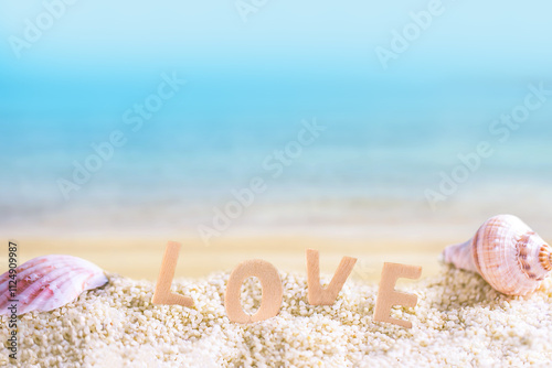 love wooden text on white sand beach with tropical blue sea and clear blue sky
