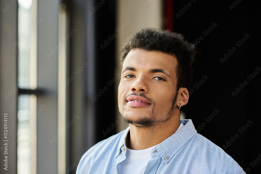Handsome man smiles softly while enjoying the warm natural light in a stylish urban setting Handsome man smiles softly while enjoying the warm natural light in a stylish urban setting
