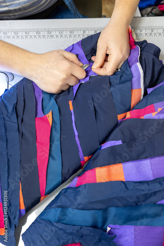 The process of sewing clothes from the remains of textiles and cut clothes. Upcycling, recycling, conscious consumption, zero waste. Youth clothing brand, sustainable fashion, reuse of materials.
