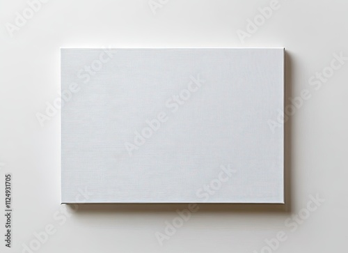 Blank white canvas on a white wall