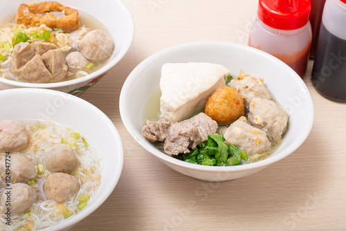 Bakso sapi, Various beef meatballs with accompaniments on wooden table. Most popular Indonesian foods photo