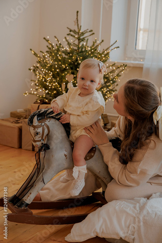 Family with a baby girl on a toy horse on New Year's Eve