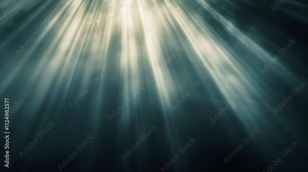 Sun rays penetrating ocean water surface creating beautiful light beams
