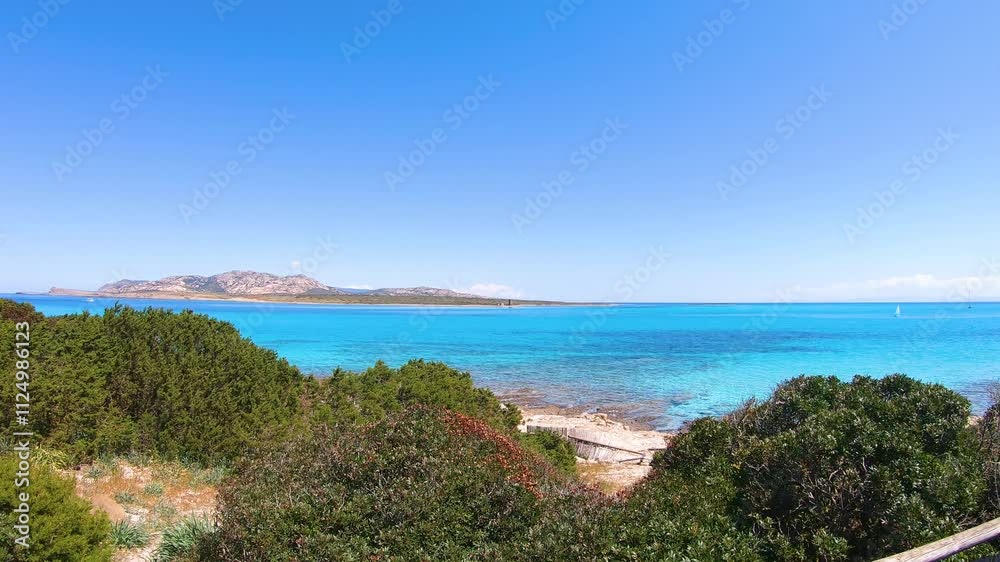 Walk by the sea in La Pelosa beach in Stintino. Sardinia, Italy