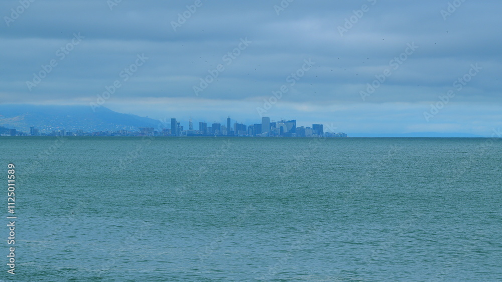 City Skyline With Marine Landscape Overcast Sea And Sky. Modern Futuristic City Located On The Surface Of The Sea. Still. City Skyline With Marine Landscape Overcast Sea And Sky. Modern Futuristic City Located On The Surface Of The Sea. Still.