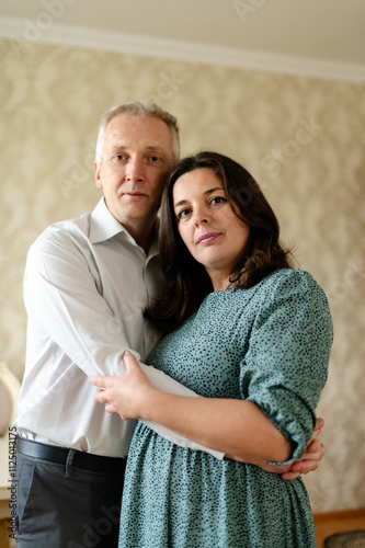 Couple hugging. Portrait of husband and wife. Looking at camera