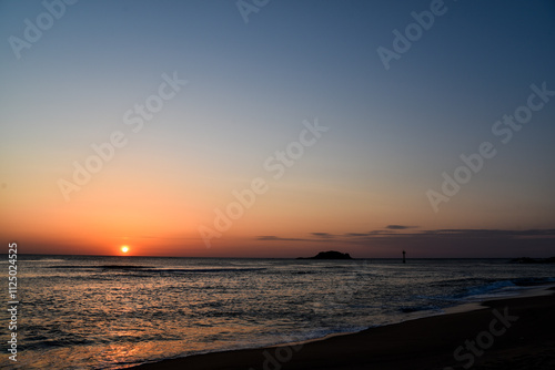 The sun is setting over the ocean