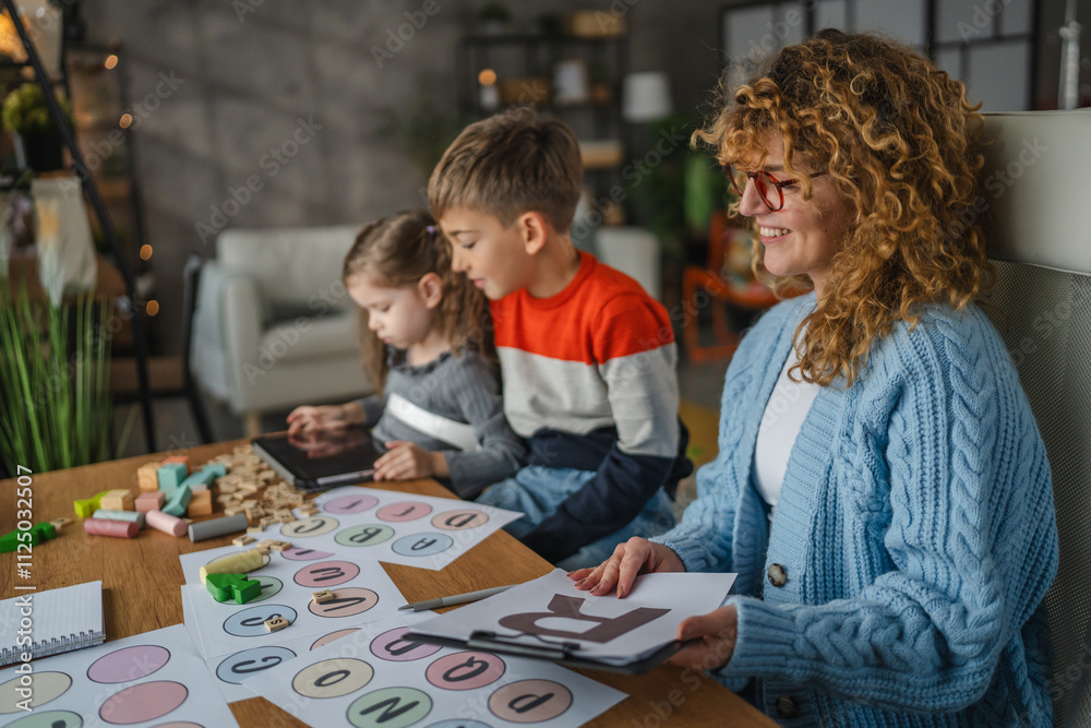 woman speech teacher with boy and girl on private lesson at home woman speech teacher with boy and girl on private lesson at home