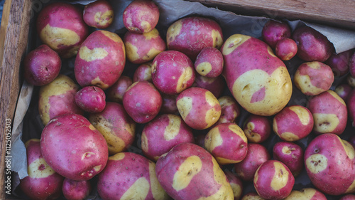 organic potato variety with original spotted skin close-up in a box selective focus