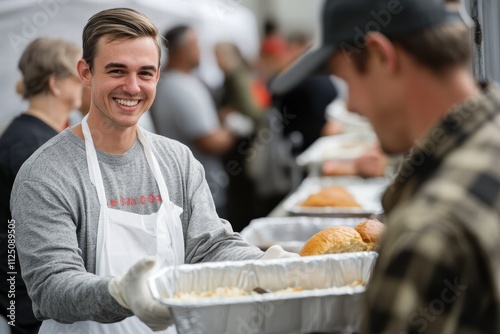 Volunteer serves lunch with a smile to a man in a community event photo