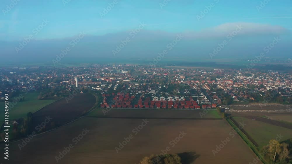 prise de vue aérienne d'un nuage cachant le soleil sur tous un village Français