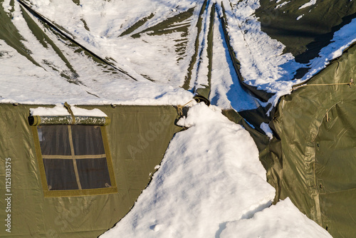 Snow-Covered Army Tent During Winter in Remote Mountainous Area