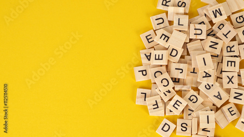 wooden letter cubes isolated on yellow background