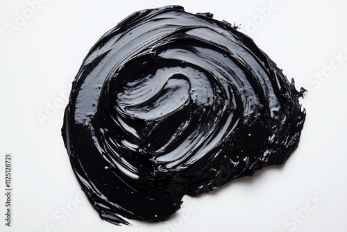 An artistic slightly circular spread of Shilajit Resin black cream on a pure white background