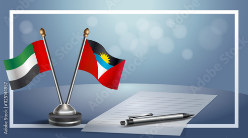 United Arab Emirate and Antigua and Barbuda National flags on small table with bokeh background, cooperative relationship