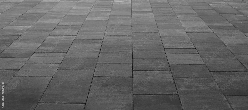 Fototapeta premium Empty grey tiled floor, pavement in perspective on modern architecture background. Abstract concrete glass building, Outdoor observation deck. street urban tile flooring. paving stones. blurred city