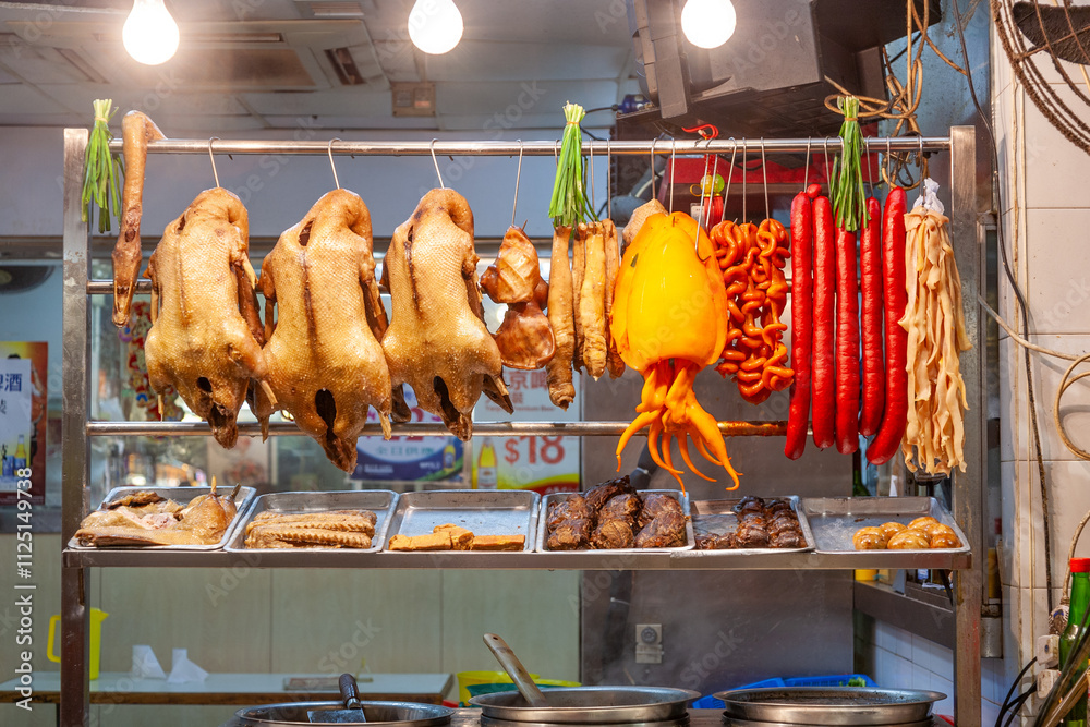 Naklejka premium delicious food like dugs,sausages, vegetables at the night market fresh grilled in Hongkong