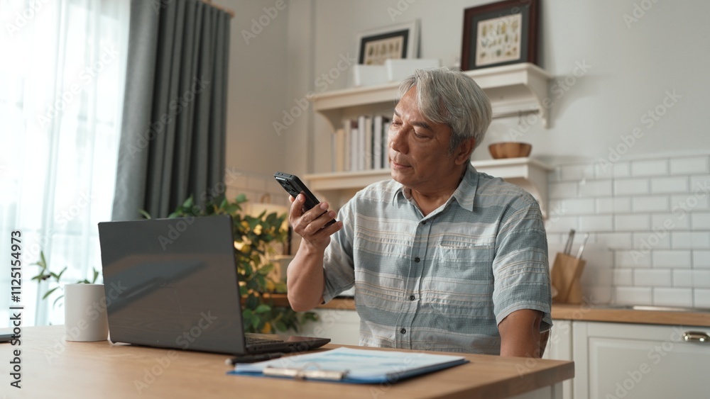 Stressed senior manager talking to colleague by using smart phone and planning marketing strategy. Businessman checking report and calling colleague while sitting at home. Remote working. Myrmidon. Stressed senior manager talking to colleague by using smart phone and planning marketing strategy. Businessman checking report and calling colleague while sitting at home. Remote working. Myrmidon.