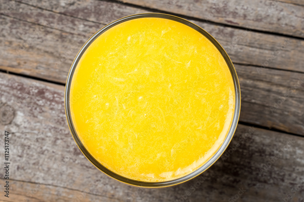 Freshly squeezed orange juice on wooden table Freshly squeezed orange juice on wooden table