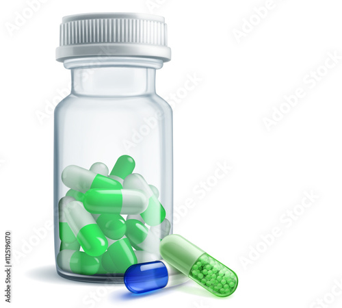A clear medicine bottle with plastic cap filled with green capsules, next to it are two capsules - blue and green.