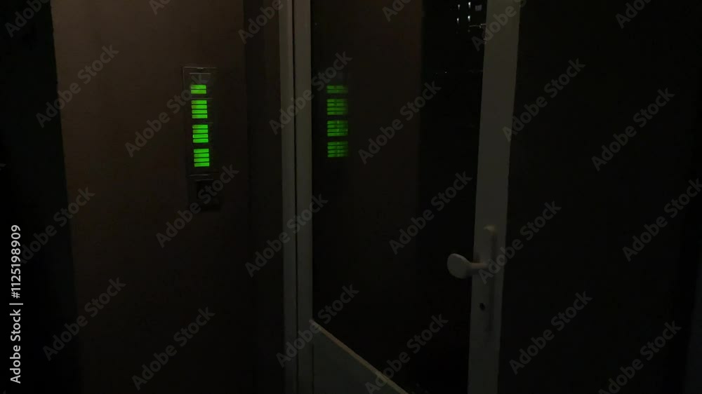 Doors button panels outdoor displaying active green indicators set against a dark environment or setting Doors button panels outdoor displaying active green indicators set against a dark environment or setting