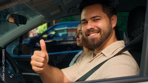 Family trip Caucasian happy woman female girl sitting inside new car with male man fasten automobile seat belt test drive safety protection guy looking camera showing thumb up recommend rental service photo