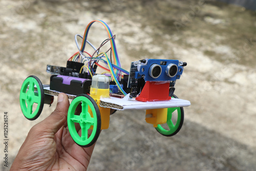 Robotic car built at home using programmable controller that follows human held in the hand that uses infrared and ultrasonic sensor photo