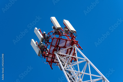 The communication tower of the mobile operator. View of the telecommunication equipment and antennas installed on the communication tower. photo